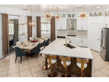 Bright open kitchen with island, marble countertops, stainless steel appliances, modern lighting, and breakfast nook at 84 E Joseph Way, Gilbert, AZ 85295
