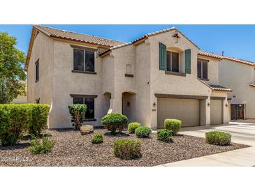 Charming two-story home with a well-manicured front yard and an attached two-car garage at 14129 W St Moritz Ln, Surprise, AZ 85379