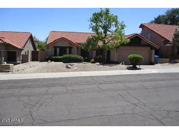 Charming single-story home with desert landscaping and a red tile roof at 1819 E Sheena Dr, Phoenix, AZ 85022