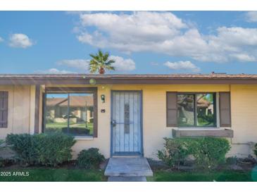Inviting front entryway with a secure screen door, neat landscaping, and sunny curb appeal at 2440 N 22Nd Ave, Phoenix, AZ 85009