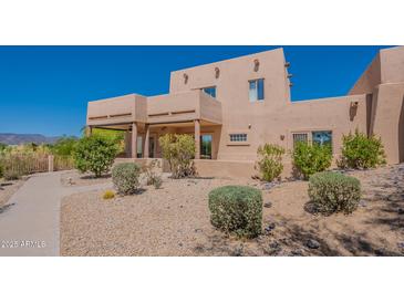 Charming two-story home with desert landscaping and inviting front walkway. Located in a sunny, desirable area at 38065 N Cave Creek Rd # 52, Cave Creek, AZ 85331