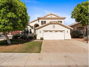 Charming two-story home featuring a well-maintained lawn, mature trees, and a spacious two-car garage at 20404 N 28Th Pl, Phoenix, AZ 85050