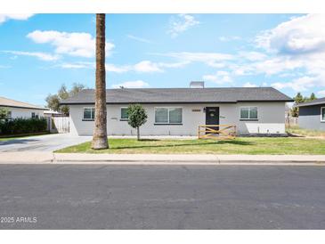 Charming single-story home features a well-maintained lawn and welcoming curb appeal at 2044 W 1St St, Mesa, AZ 85201