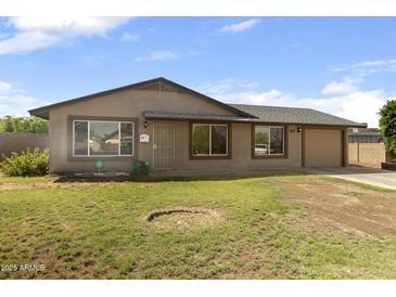 Charming single story home with low maintenance front yard, attached garage, and neutral color palette at 2201 W Wethersfield Rd, Phoenix, AZ 85029