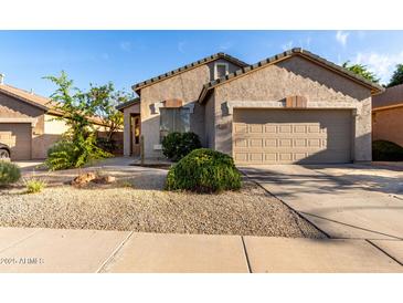 Charming single-story home with a neutral-toned stucco exterior, low maintenance landscaping, and a two-car garage at 2641 E Binner Dr, Chandler, AZ 85225
