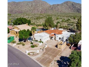 Elegant home featuring a red tile roof, desert landscaping, and a mountain view at 3738 E Kachina Dr, Phoenix, AZ 85044