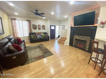 Inviting living room features hardwood floors, fireplace, and comfortable leather sofas at 4805 E Kachina Trl # 25, Phoenix, AZ 85044