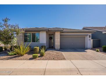 Charming single-story home featuring a well-manicured lawn and a two-car garage at 4925 S Turbine --, Mesa, AZ 85212