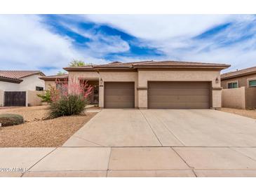 Charming single-story home featuring a two-car garage, desert landscaping, and neutral color palette at 5749 S Dragoon Dr, Chandler, AZ 85249