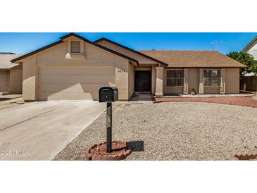 Charming single-story home with a low-maintenance gravel yard and a secure front entrance at 6602 W Ironwood Dr, Glendale, AZ 85302