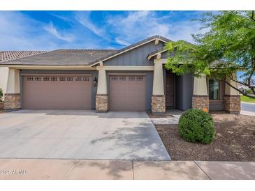 Charming single-Gathering home featuring a three-car garage and stone accents on the front facade at 809 W Coles Rd, Phoenix, AZ 85041