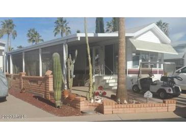 Charming single-story home with a well-maintained brick garden and beautiful desert landscaping at 1311 W Chesapeake Dr, Apache Junction, AZ 85119