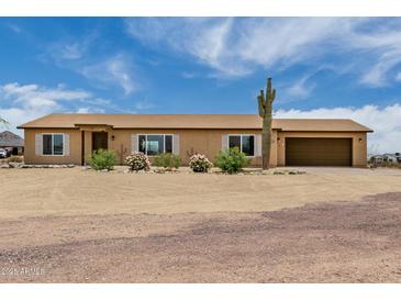 Charming single-story home boasts desert landscaping, a neutral color scheme, and an attached two car garage at 16415 W Oyer Ln, Surprise, AZ 85387
