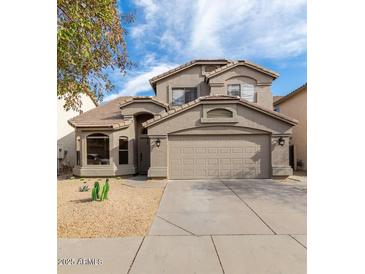 Charming two-story home featuring a desert landscape, a two-car garage, and a neutral color scheme at 20929 N 37Th Way, Phoenix, AZ 85050