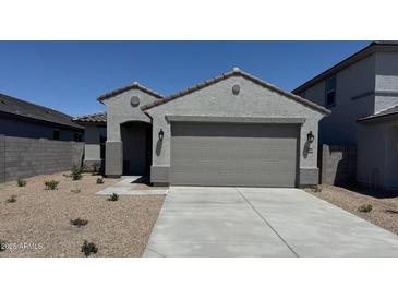 Charming single-story home featuring desert landscaping and a neutral color palette at 22895 N 183Rd Dr, Surprise, AZ 85387