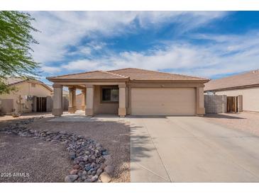 Charming single-story home with a low-maintenance desert-style front yard and a two-car garage at 2518 W Carson Rd, Phoenix, AZ 85041