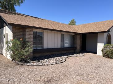 Charming single-story home featuring desert landscaping, brick accents and modern windows at 3102 N Woodburne Dr, Chandler, AZ 85224
