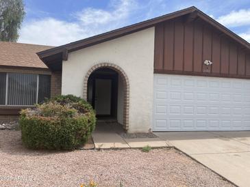 Inviting single-Gathering home featuring an arched entryway and attached two-car garage at 3102 N Woodburne Dr, Chandler, AZ 85224
