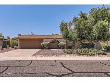 Charming single-story home featuring a two-car garage and a well-maintained front yard with mature trees at 3924 E Cortez St, Phoenix, AZ 85028