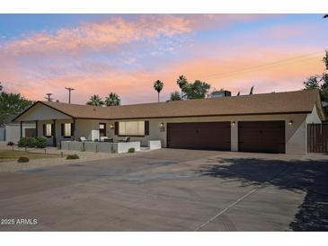 Charming single story home with a three car garage and beautiful desert landscaping and front courtyard at 4920 E Osborn Rd, Phoenix, AZ 85018