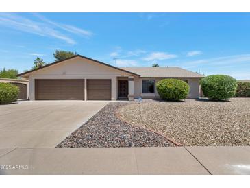 Charming single-story home featuring a two-car garage and low maintenance landscaping at 7530 E North Ln, Scottsdale, AZ 85258