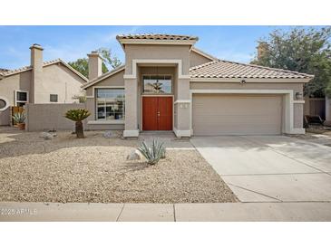 Charming single-story home with a well-manicured, desert landscape and a two car garage at 115 W El Freda Rd, Tempe, AZ 85284