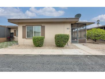 Cozy single-story home featuring a screened entryway and low maintenance front yard landscaping at 13611 N 98Th Ave # D, Sun City, AZ 85351