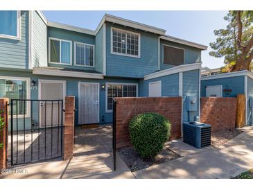 Blue two-story home featuring brick accents, gated entry and well-maintained landscaping at 2301 E University Dr # 172, Mesa, AZ 85213