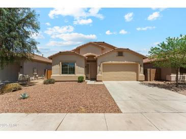 Charming single-story home featuring a well-maintained front yard and a two-car garage at 43884 W Kramer Ln, Maricopa, AZ 85138
