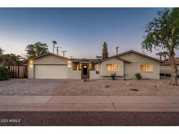 Charming single-story home with desert landscaping, a paver driveway, and inviting curb appeal at 8408 E Rancho Vista Dr, Scottsdale, AZ 85251