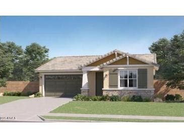 Charming single-story home with a two-car garage, covered entryway, and landscaped front yard at 16714 W Audrey Ln, Surprise, AZ 85387