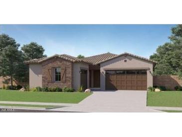 Charming single-story home featuring a stone facade, two-car garage, and well-manicured lawn at 16933 W Bronco Trl, Surprise, AZ 85387