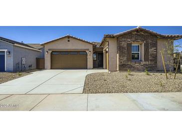 Charming single-story home featuring a two-car garage, desert landscaping, and a welcoming entrance at 16933 W Bronco Trl, Surprise, AZ 85387