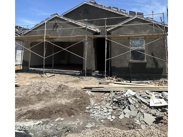 View of a home under construction with scaffolding and building materials in the front yard at 1960 E Bucking Bronco Dr, San Tan Valley, AZ 85140