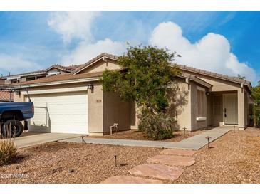 Charming single-story home featuring a well-maintained yard with desert landscaping and a two car garage at 4038 E Wrangler Ct, Gilbert, AZ 85297