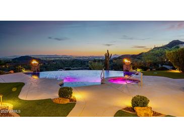 An outdoor pool area featuring a pool, hot tub, and sunset views at 4328 N Pinnacle Ridge Cir, Mesa, AZ 85207