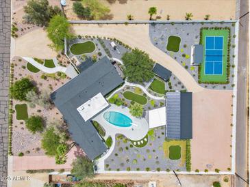An aerial view showcasing the estate's lush landscaping, pool, pickleball court, garages, and unique layout at 6310 E Desert Cove Ave, Scottsdale, AZ 85254