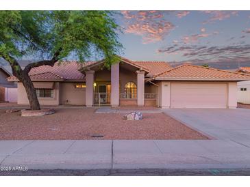 Charming single-story home featuring a well-maintained front yard and two-car garage at 7833 S Kenneth Pl, Tempe, AZ 85284