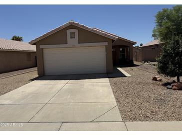 Charming single-story home with a well-maintained front yard and a two-car garage, perfect for a Gathering at 15729 W Lundberg St, Surprise, AZ 85374