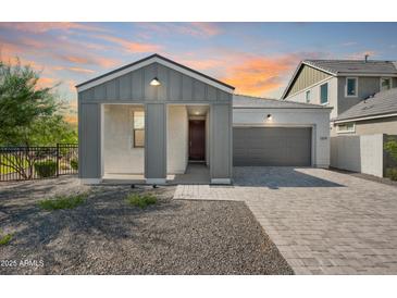 Charming single-story home featuring a gray exterior, covered porch, and brick driveway at 2324 E Marguerite Ave, Phoenix, AZ 85040