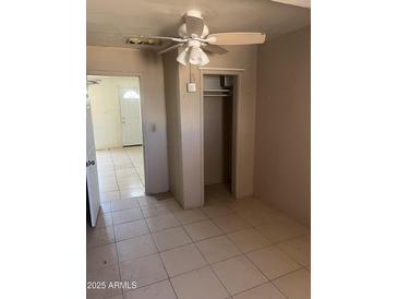 Bedroom featuring tile flooring, ceiling fan, and closet at 527 S Macdonald --, Mesa, AZ 85210