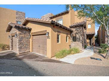 Beautiful home exterior showcasing stone accents, a two-car garage, and well-maintained landscaping at 6145 E Cave Creek Rd # 203, Cave Creek, AZ 85331