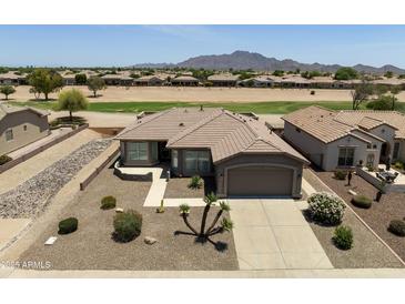 Expansive desert landscaping defines this home with a backyard view of a meticulously manicured golf course at 6811 S Four Peaks Way, Chandler, AZ 85249
