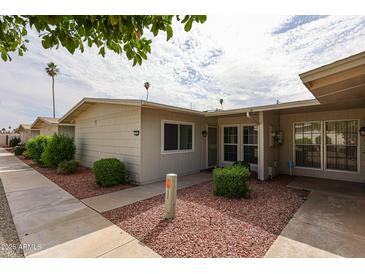 Charming single-story home featuring desert landscaping and a cozy covered entry at 10827 W Santa Fe Dr, Sun City, AZ 85351