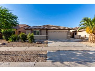 Charming single-story home with a well-maintained front yard and two-car garage at 11402 W Hadley St, Avondale, AZ 85323