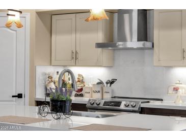 Bright kitchen featuring stainless steel appliances, light countertops, and cream colored cabinets at 508 W San Angelo St, Gilbert, AZ 85233