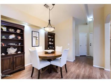 Cozy dining room featuring a round table, stylish chairs, and built-in display cabinets at 8500 E Southern Ave # 510, Mesa, AZ 85209