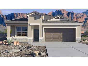 Beautiful single-story home featuring stone accents, a neutral color palette, and a spacious two-car garage at 10614 W Bloch Rd, Tolleson, AZ 85353