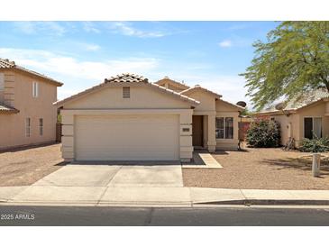 Inviting single-story home featuring a two-car garage and neutral-colored exterior at 11921 W Flores Dr, El Mirage, AZ 85335