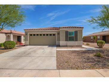 Charming single-story home with a two-car garage and neutral stucco exterior, complemented by desert landscaping at 19951 W Wilson St, Buckeye, AZ 85326
